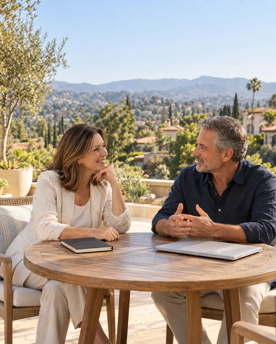 Two professionals having a relaxed conversation on a California patio